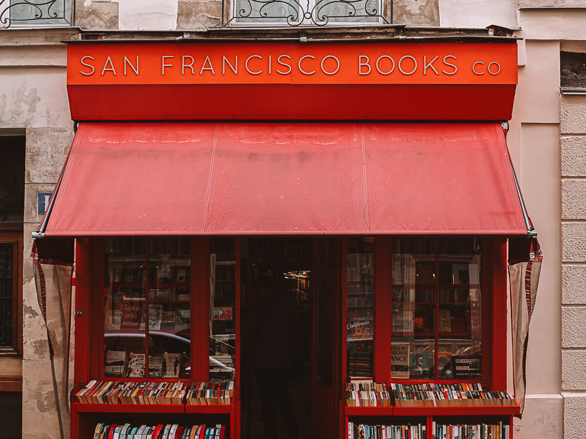 Outside San francisco Book Co - one of the only second-hand English bookshops in Paris with red exterior