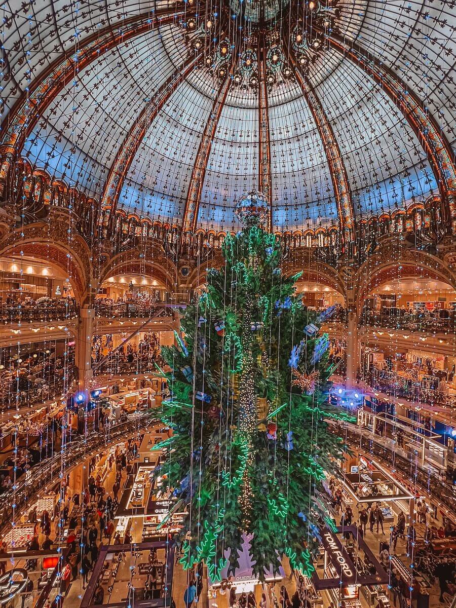 The giant Christmas tree inside Galeries Lafayette, a department store seen in The Summer I Turned Pretty Paris scenes