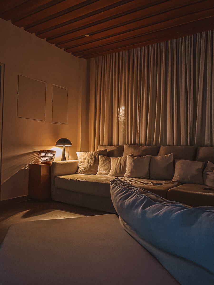 Cosy warm photo of a large sofa at night on a reading retreat in Zakynthos Greece 