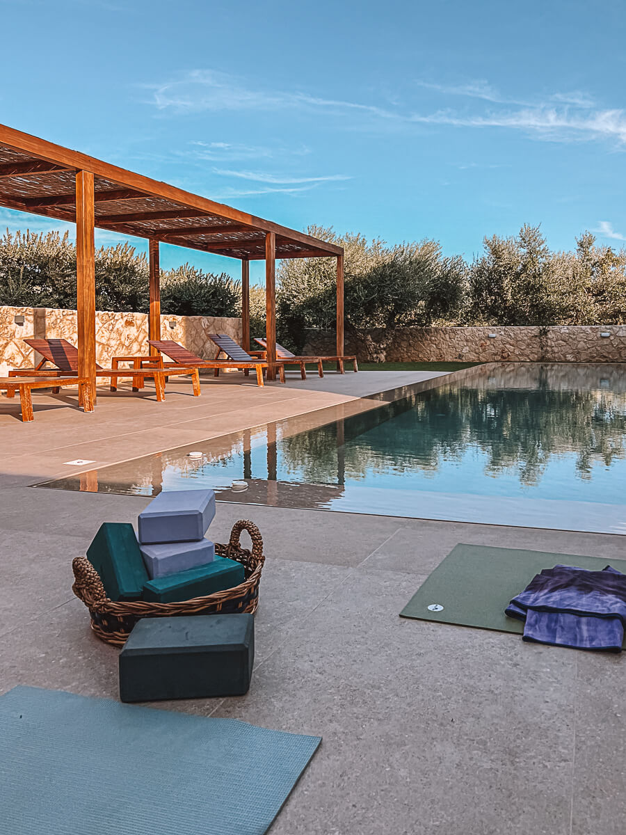 Morning yoga next to pool on beautiful reading retreat in Greece 