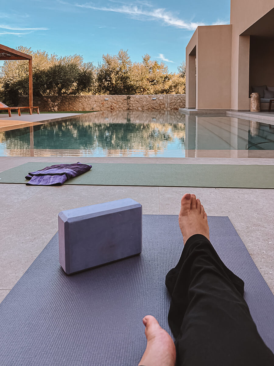Outdoor yoga in front of a beautiful blue pool in Zakynthos Greece whilst on Aweventurer's reading retreat 