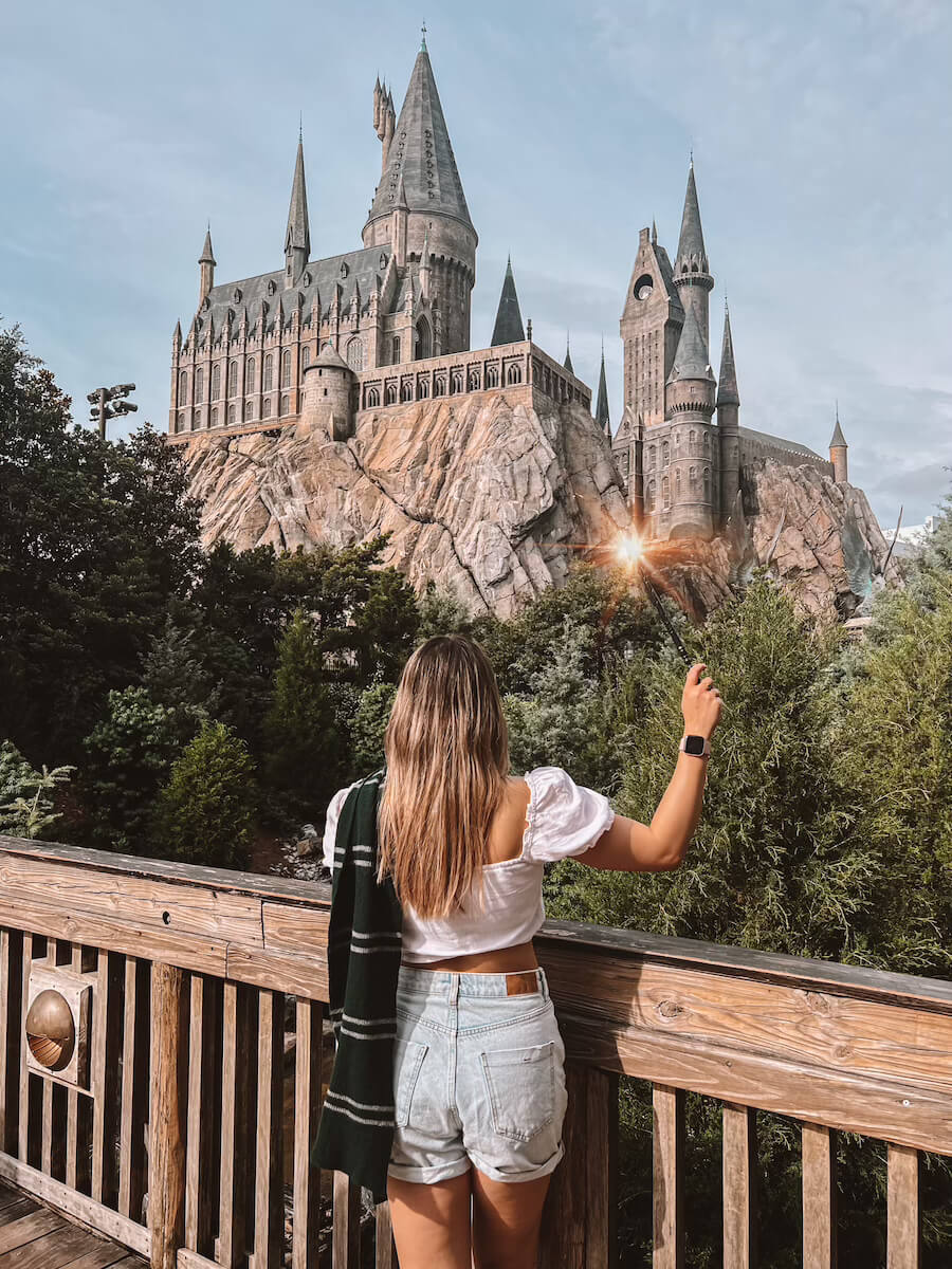 Woman with wand standing outside Hogwarts at Universal Studios Orlando 