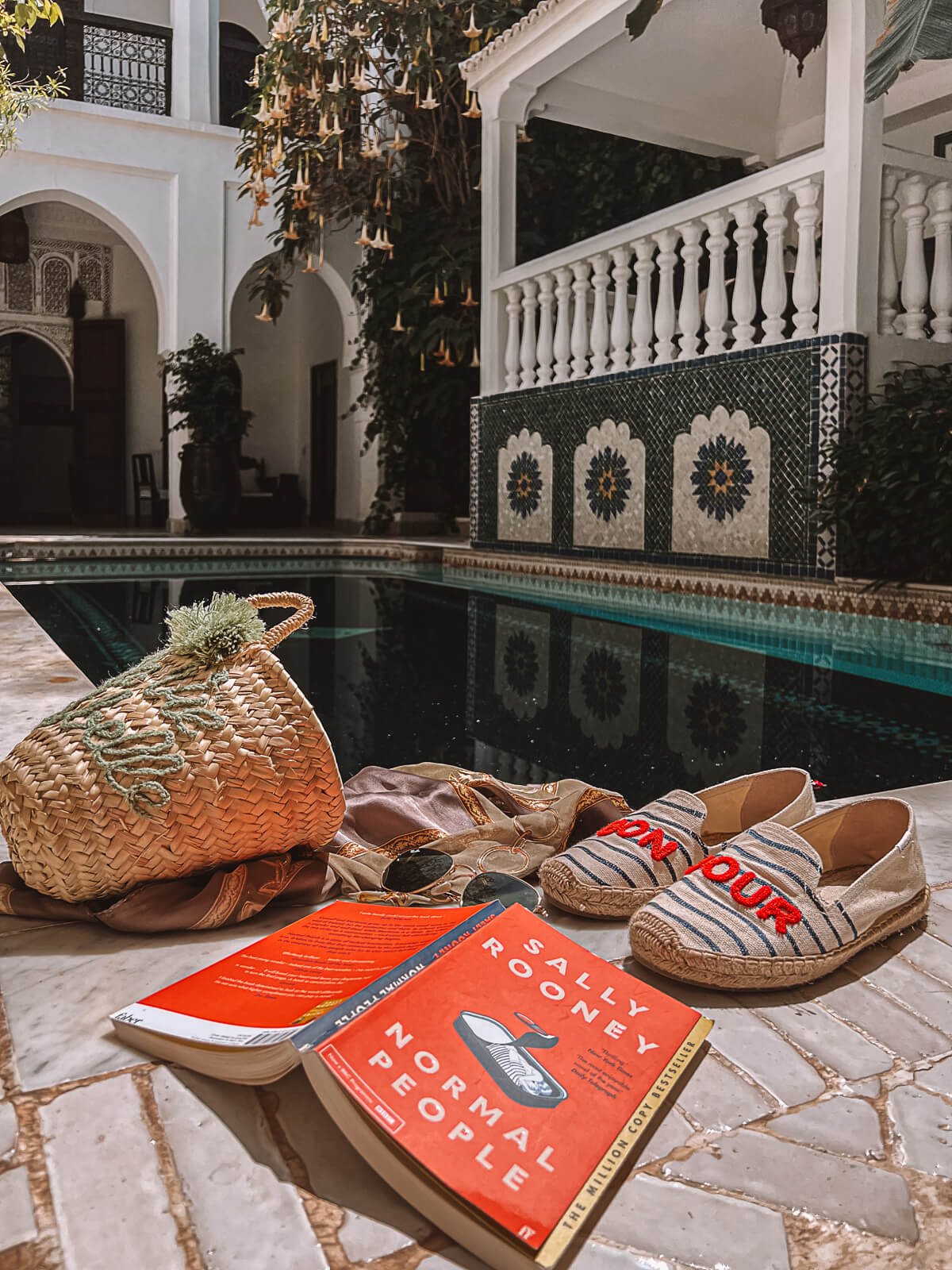 Copy of Normal People by Sally Rooney open on the side of a pool
